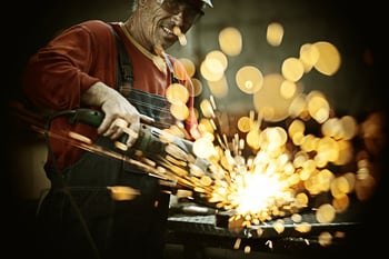 Industrial worker cutting and welding metal with many sharp sparks-4